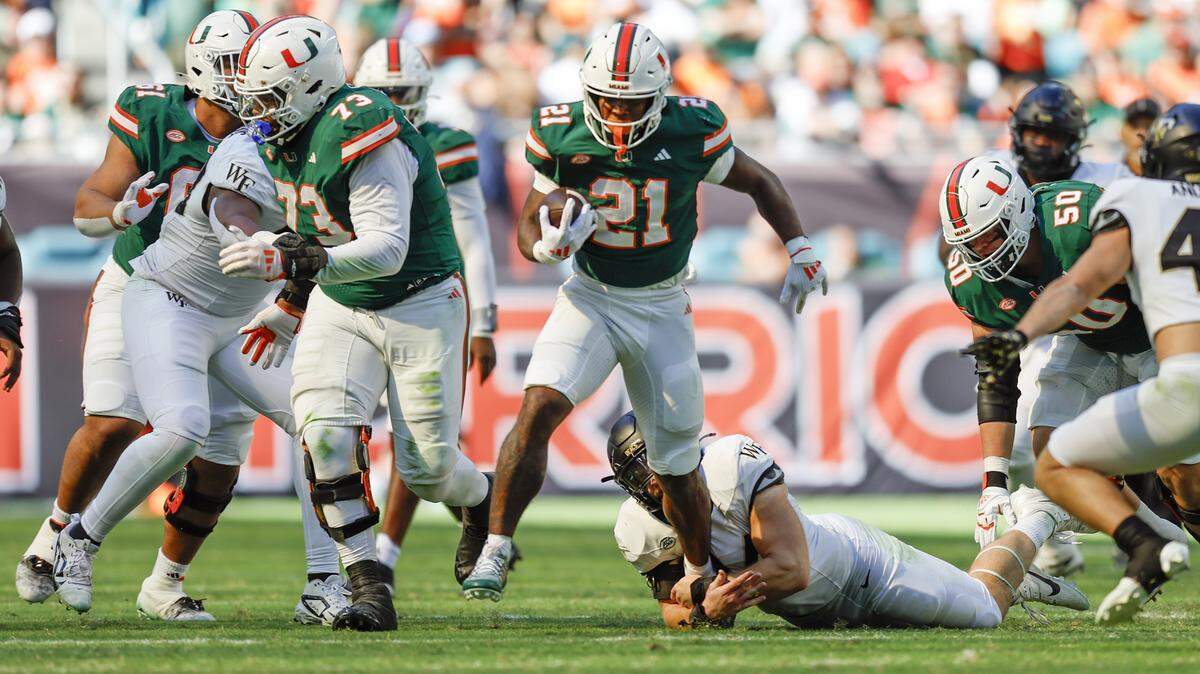 Miami Hurricanes running back Jordan Lyle (21) on a carry in the first half against the Wake Forest Demon Deacons of their NCAA game in Miami Gardens, Florida, on Saturday, November 23, 2024. 