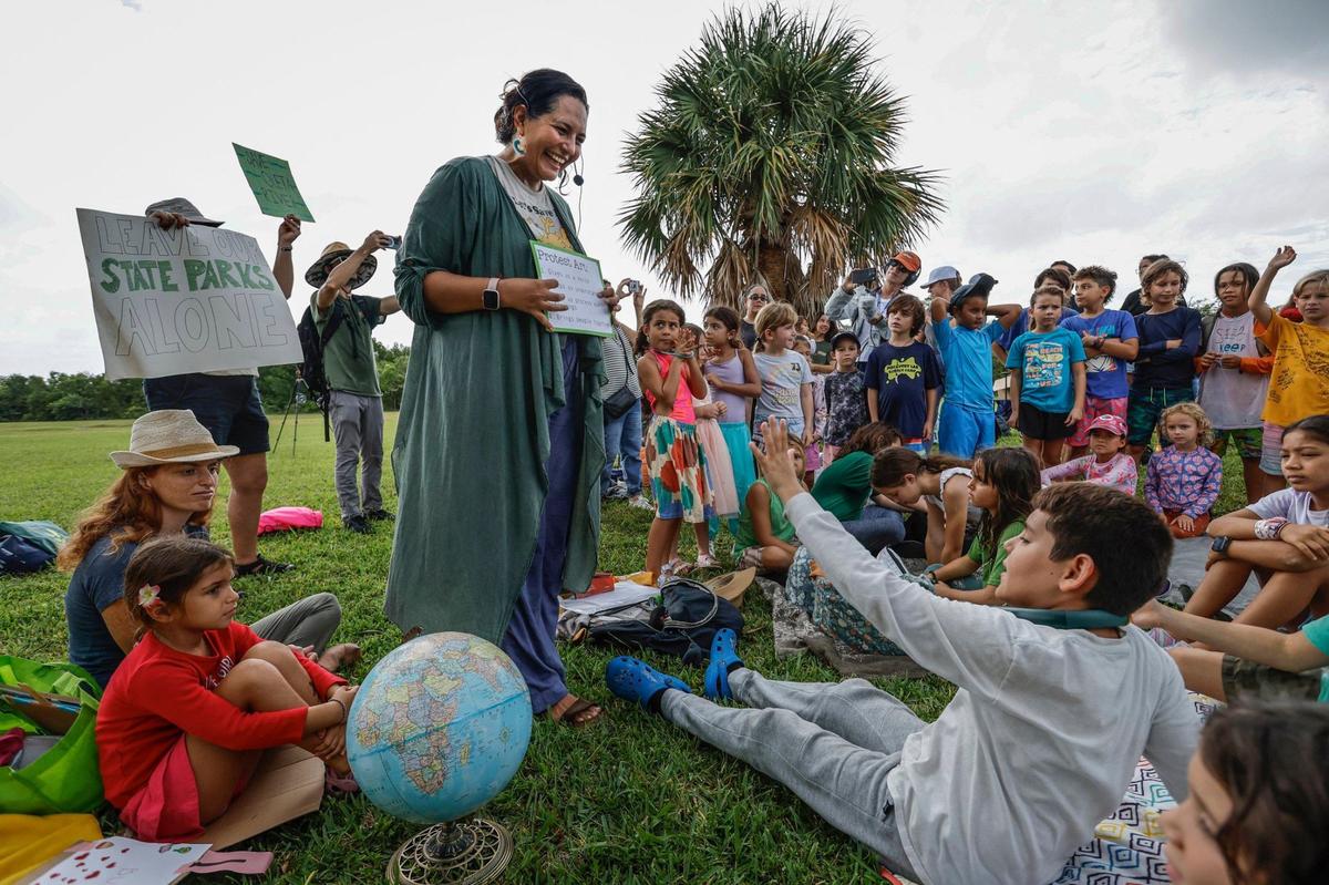 Catalina Lemaitre speaks to school children as they join protesters with Keep Florida State Parks Wild-Defend Oleta State Park against the Florida Department of Environmental Protection’s plan to add pickleball courts, cabins, and a disc golf course to Oleta River State Park in North Miami Beach, Florida on Tuesday, August 27, 2024.