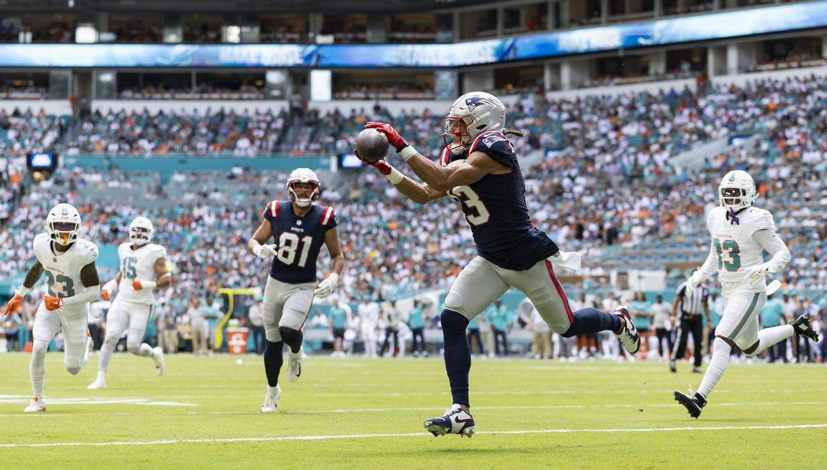 New England Patriots wide receiver Mack Hollins (13) catches a touchdown pass against the Miami Dolphins in the first half of their NFL game at Hard Rock Stadium.