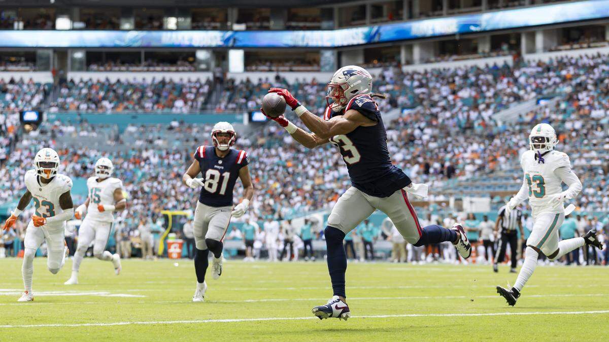 New England Patriots wide receiver Mack Hollins (13) catches a touchdown pass against the Miami Dolphins in the first half of their NFL game at Hard Rock Stadium on Sunday, Sept. 14, 2025, in Miami Gardens, Fla.
