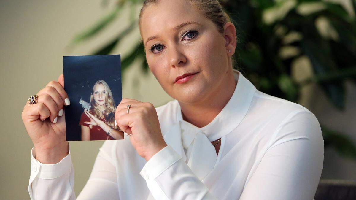 Virginia Giuffre holds a photo of her younger self.
