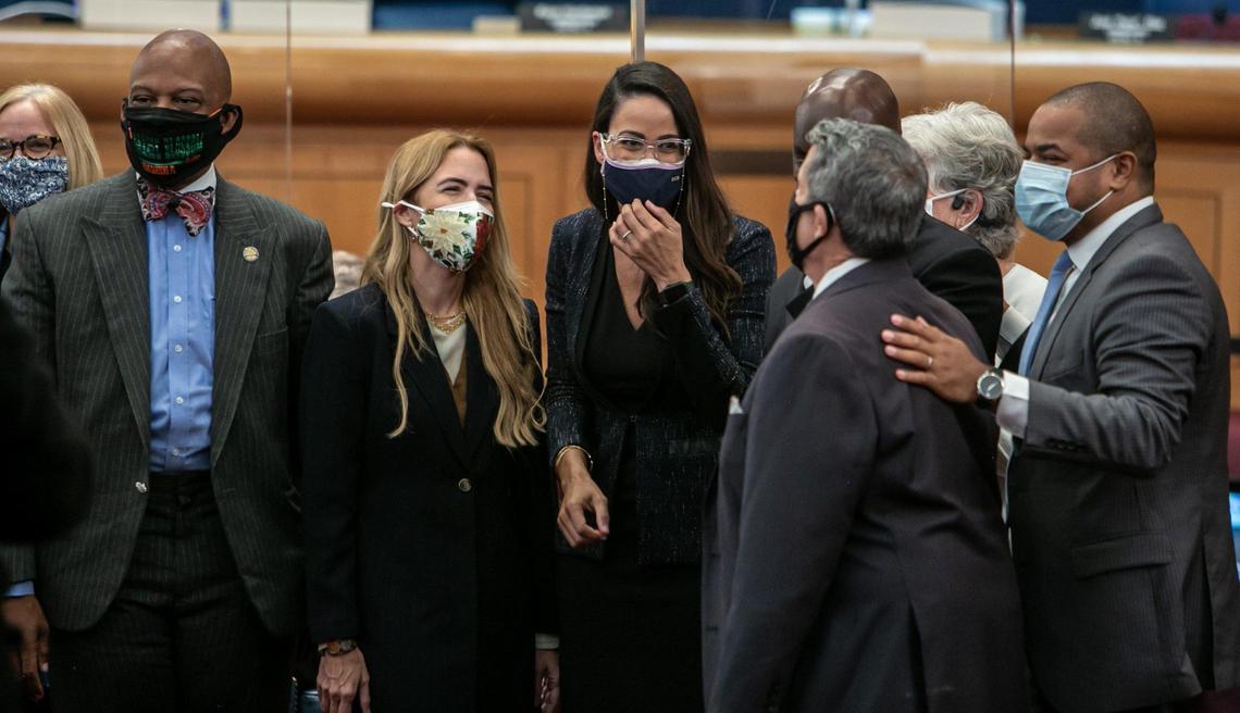 Newly appointed Miami-Dade County Commissioner for District 8, Danielle Cohen Higgins, center, is joined by other commissioners on the floor of the chambers after the vote appointing her on Monday, Dec. 7, 2020. Commissioners are, from left, Eileen Higgins, Oliver G. Gilbert III, Raquel Regalado, Cohen Higgins, José ‘Pepe’ Diaz, Kionne McGhee, Sally Heyman and Keon Hardemon.