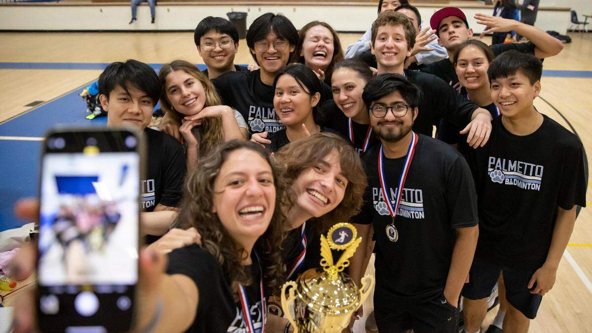 Students from Miami Palmetto Senior High School take a selfie after winning the GMAC badminton championship trophy at G Holmes Braddock Senior High on Tuesday, April 18, 2023, in Miami, Fla.