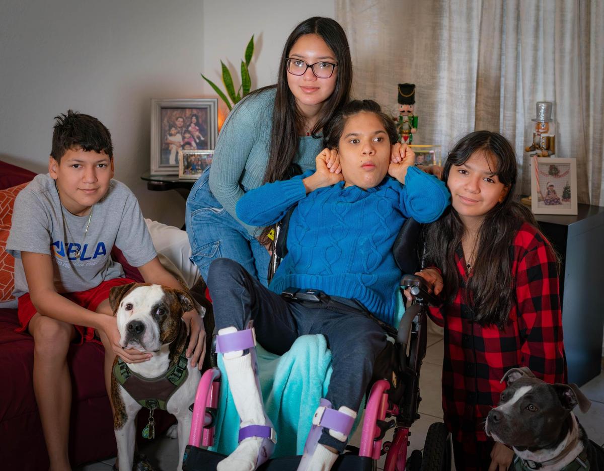 From left to right, siblings Ricardo, 14, Patricia,16, Standarlyn, 20, and Camila Muñoz Delgado pose for a photo together at their apartment in Homestead.