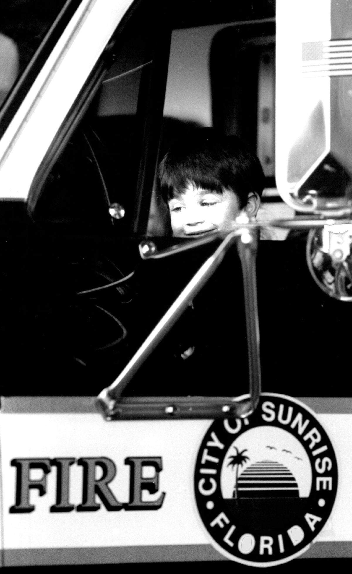 David Henning, 3, of Sunrise is the first to “drive” a new rescue truck as the city of Sunrise officially opened its newest station across from the Sawgrass Mills mall.