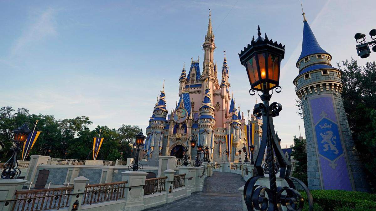 Newly painted Cinderella’s castle at the Magic Kingdom at Walt Disney World is seen with the the crest to celebrate the 50th anniversary of the theme park Monday, Aug. 30, 2021, in Lake Buena Vista, Fla.