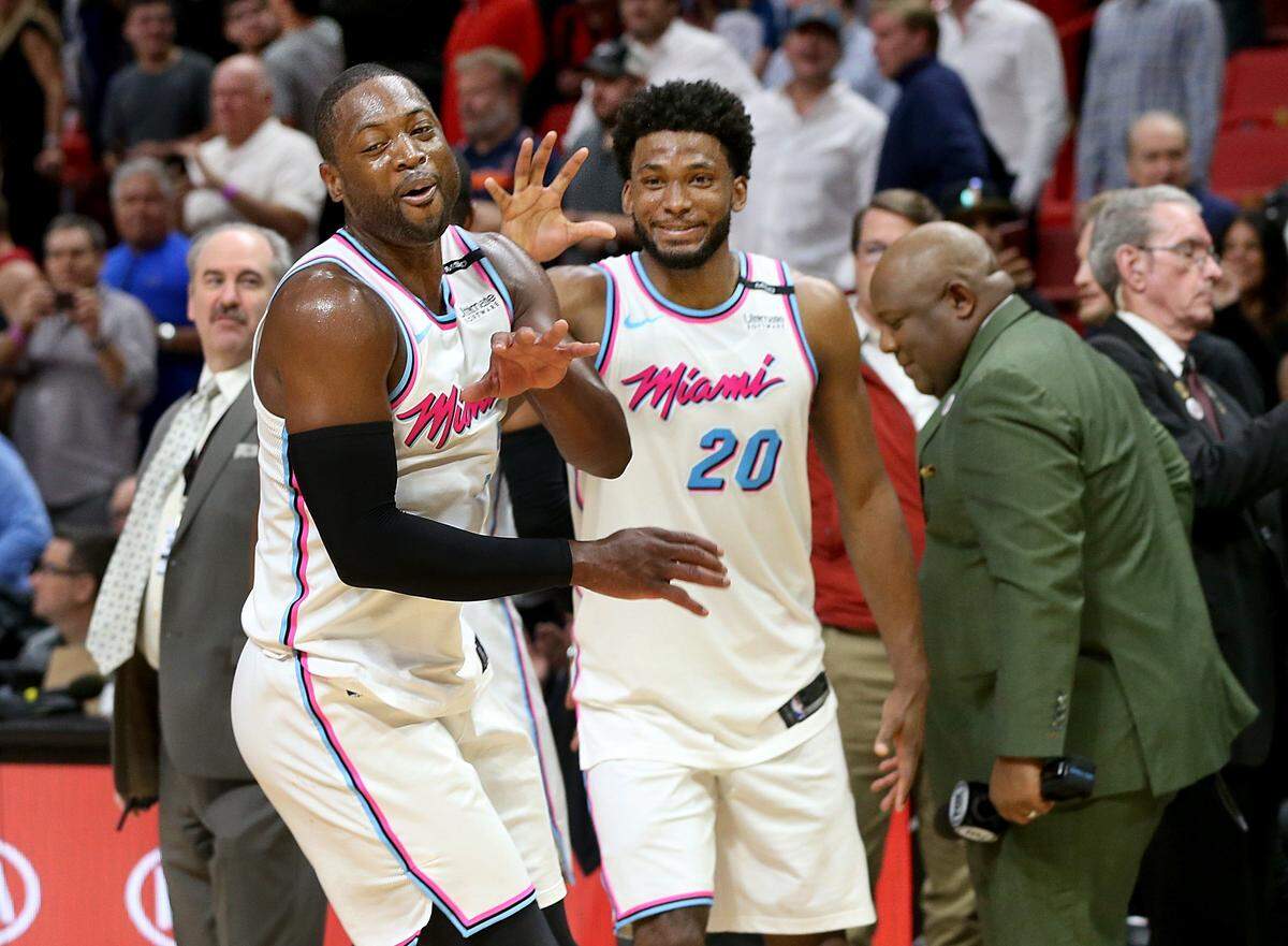 Heat guard Dwyane Wade and forward Justise Winslow celebrate their 108-99 victory against the Philadelphia 76ERS, at AmericanAirlines Arena in Miami on Thursday, March 08, 2018.