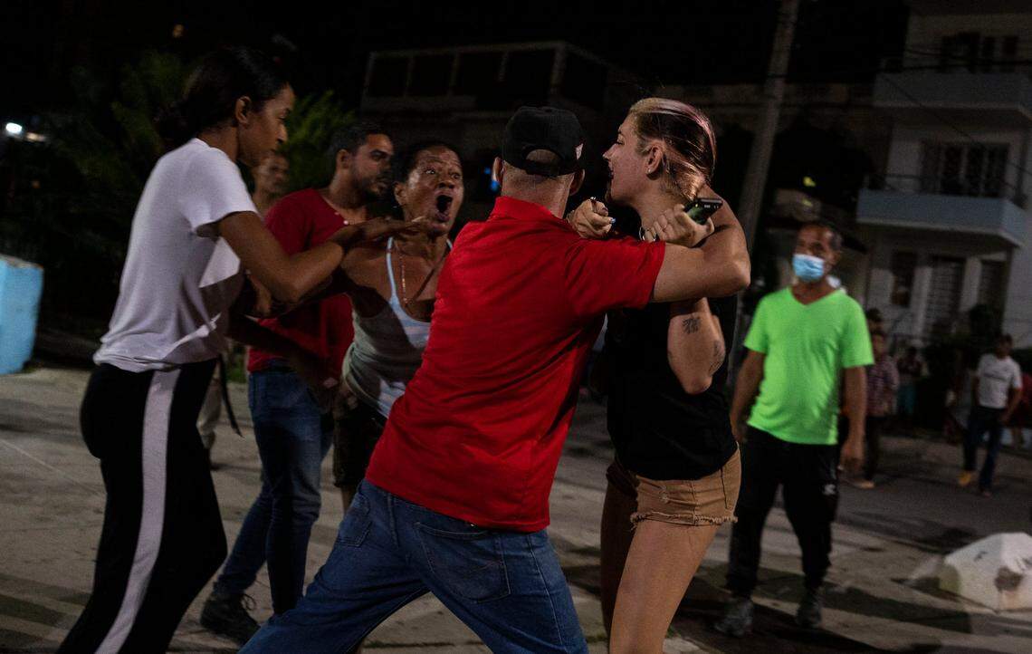 A plain-clothed police officer detains a demonstrator during a protest calling for the restoration of electrical service after six days of blackouts due to the devastation of Hurricane Ian in Havana, Cuba, Saturday, Oct 1, 2022.