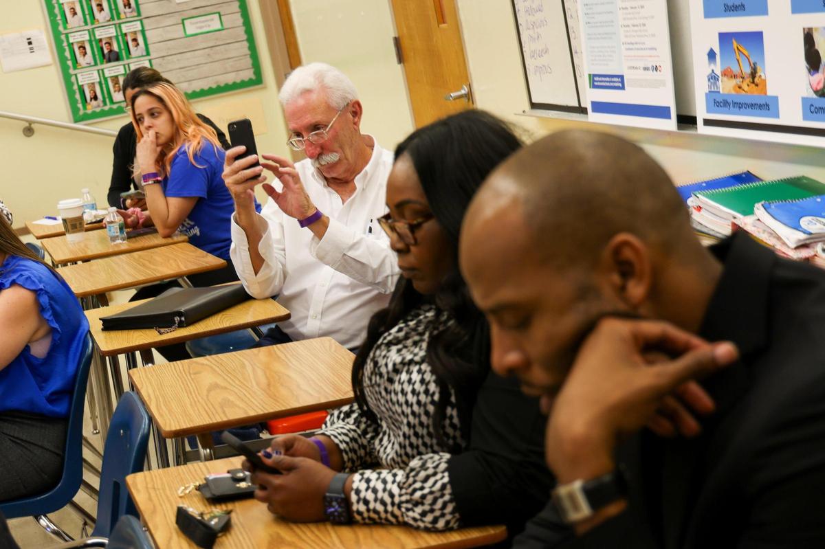 Stakeholders and parents answer questions and write ideas about school closures in a program called ThoughtExchange during the third community meeting the Broward school district hosted to get input.