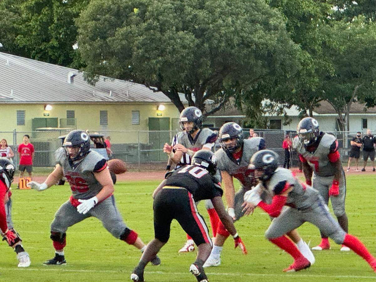 Columbus quarterback Jason Barket Jr. prepares to snap the ball during the Explorers’ game on Thursday night at Southridge Stadium.