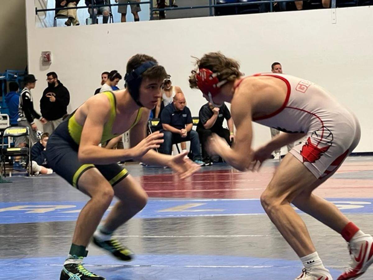 Danil Korochenskiy of Cardinal Gibbons seen here wrestling against Charles Dion of Douglas in a 170-pound semifinal match. He advanced to the championship match were he defeated Diego Ramos Padlil of Western 8-2 on Saturday night at the BCAA championships at Pompano Beach High.