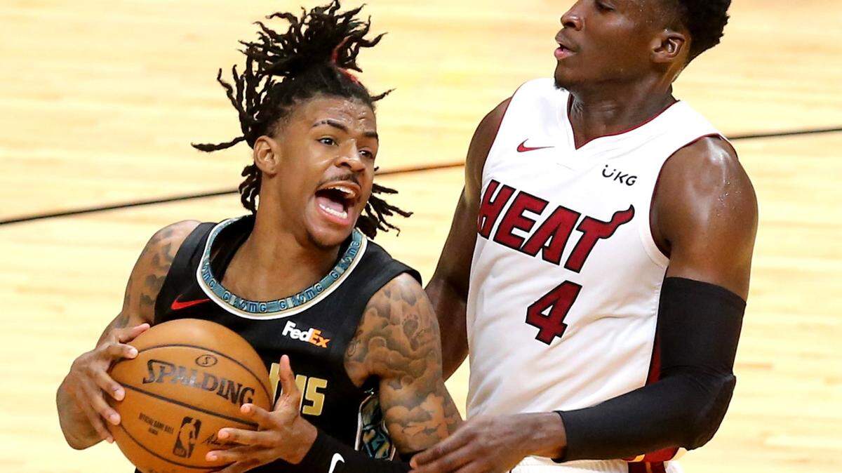 Miami Heat Victor Oladipo (4) and Memphis Grizzlies Ja Morant (12) in the fourth quarter at the AmericanAirlines Arena in Miami, Florida, Tuesday, April 6, 2021.