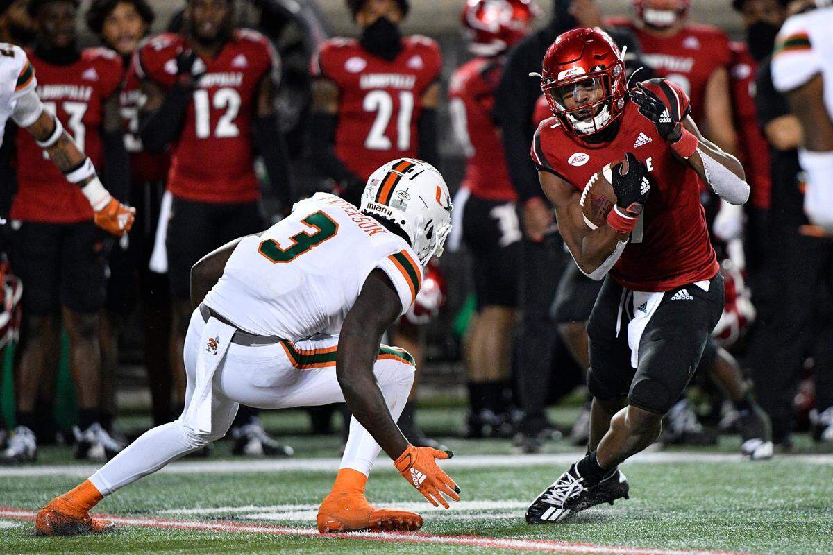 Sep 19, 2020; Louisville, Kentucky, USA; Louisville Cardinals wide receiver Tutu Atwell (1) runs the ball against Miami Hurricanes linebacker Gilbert Frierson (3) during the second half of play at Cardinal Stadium. Miami defeated Louisville 47-34. Jamie Rhodes-ACC Pool