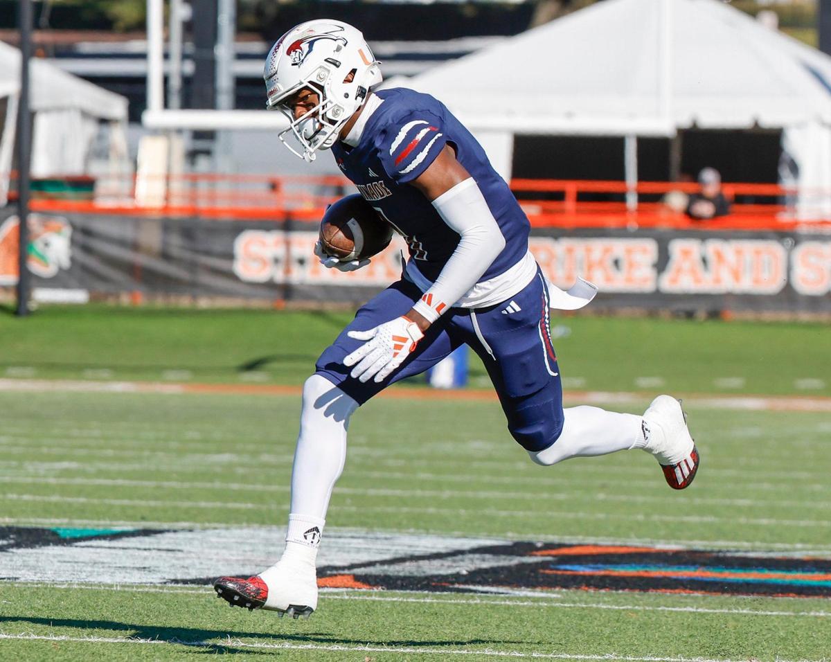 Chaminade-Madonna Lions Joshisa Trader (1) scores on a pass reception in the first quarter against the Clearwater Central Catholic Marauders during the Class 1M, Region 3, District 6, State Championship game at Bragg Memorial Stadium in Tallahassee, Florida, on Thursday, December 7, 2023.