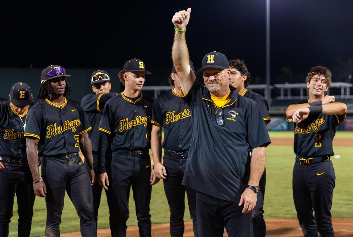 American Heritage Patriots Coach Bruce Aven celebrates with his players winning the baseball championship game of their Class 4A, against the Mulberry Panthers at Hammond Stadium on Tuesday, May 20, 2025, in Fort Myers, Fla.