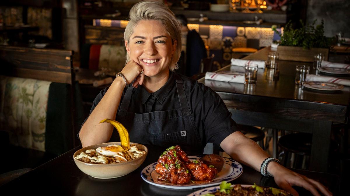 Chef Eileen Andrade poses with some of her culinary creations at Finka Table & Tap in Kendall, which serves Cuban-Korean-Peruvian cuisine and is celebrating its 10th anniversary.