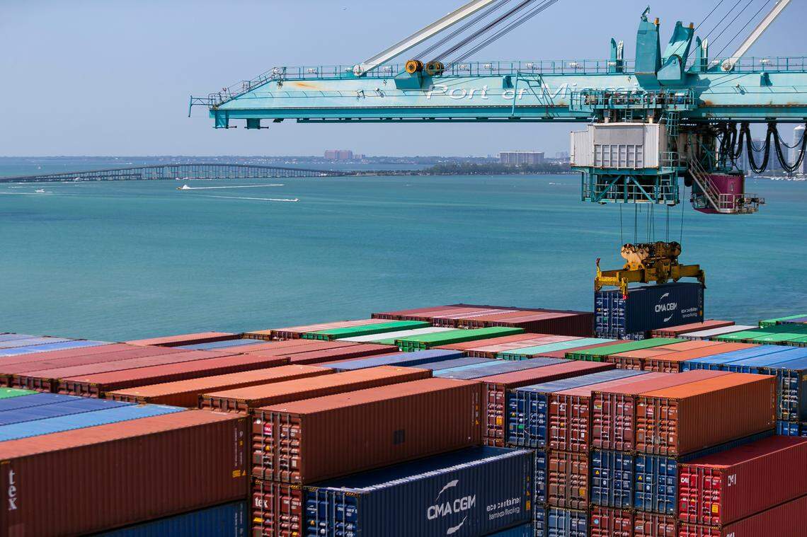 A longshoreman operates a gantry to offload containers from a docked cargo ship at PortMiami on Saturday, February 20, 2021.