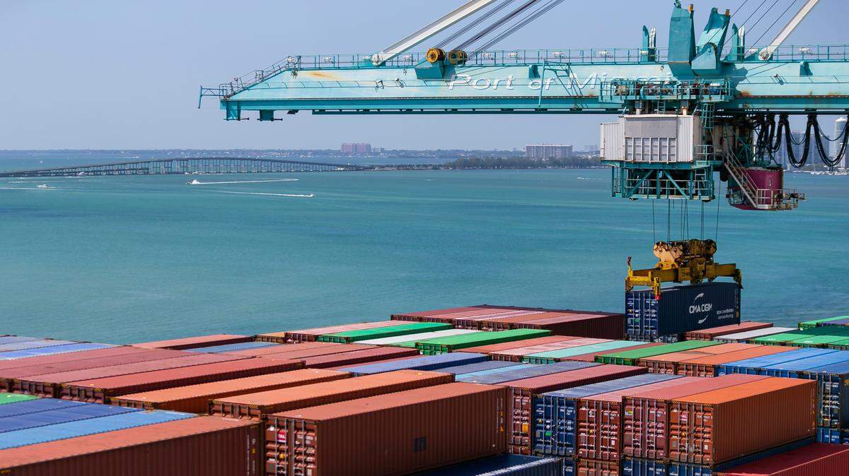 Gantry crane offloads containers from a docked cargo ship at PortMiami in February.