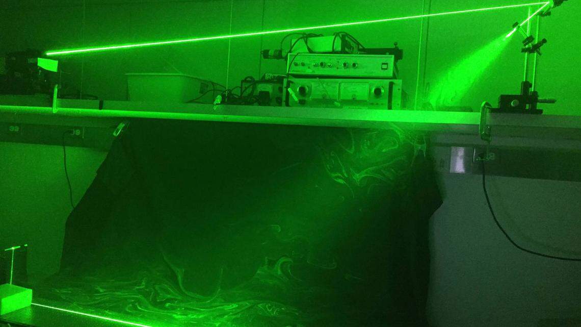 Princeton University researchers used a laser sheet to illuminate saliva droplets coming out of a speaking mouth.