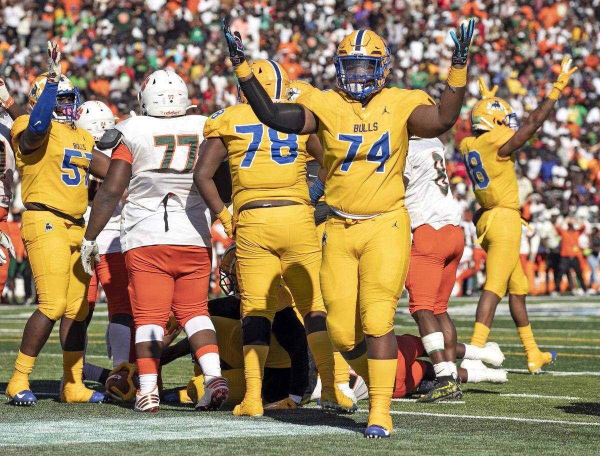 The Bulls Tellek Lockette (74) signals a touchdown by Nataniel Noel (2) in the fourth quarter as Miami Northwestern Bulls play Jones Fightin Tigers for the Class 5A FHSAA State Championship at Daytona Stadium in Daytona Beach on Saturday, December 14, 2019.
