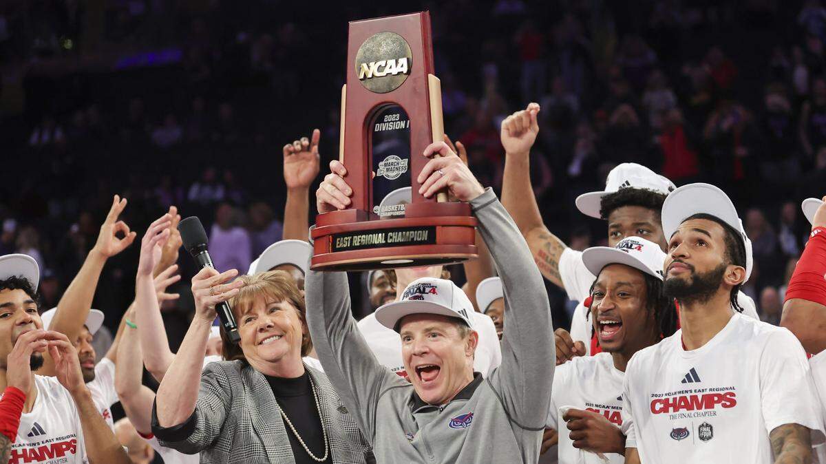 Mar 25, 2023; New York, NY, USA; Florida Atlantic Owls head coach Dusty May raises the East Regional Champion trophy following their 79-76 victory against the Kansas State Wildcats in an NCAA tournament East Regional final at Madison Square Garden. Mandatory Credit: Brad Penner-USA TODAY Sports