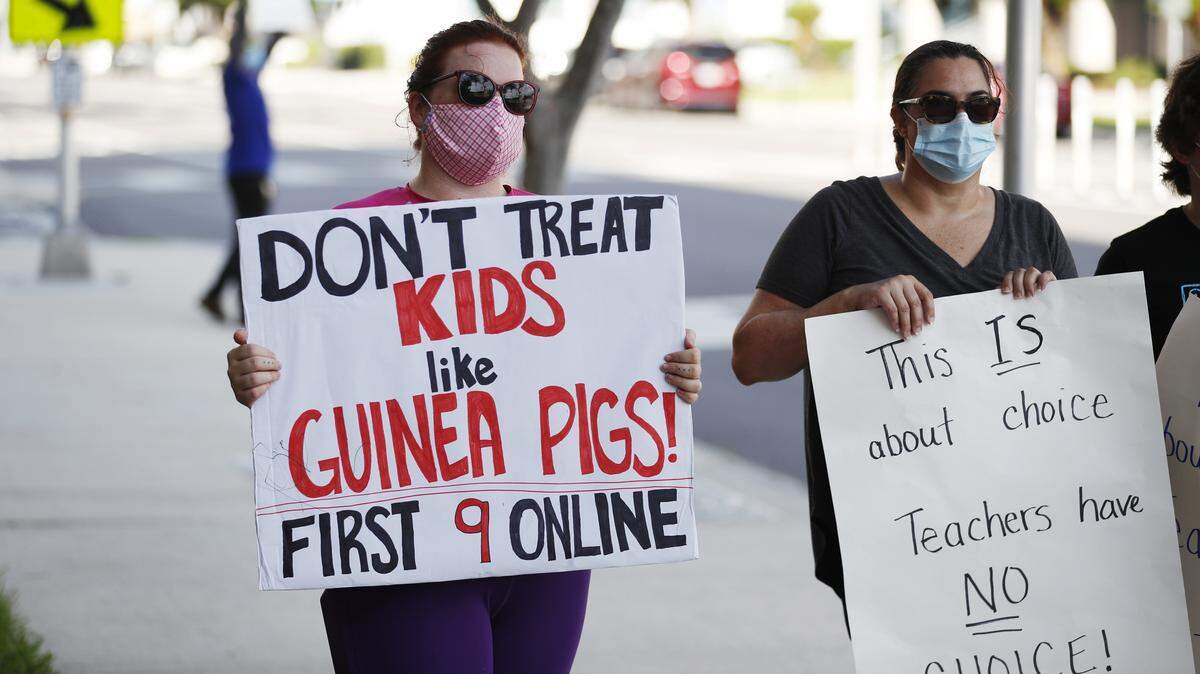 Teachers who oppose schools reopening during the COVID-19 pandemic protest ahead of the school board meeting to decide at the Hillsborough County Public Schools district office on Aug. 6, 2020, in Tampa, Florida.