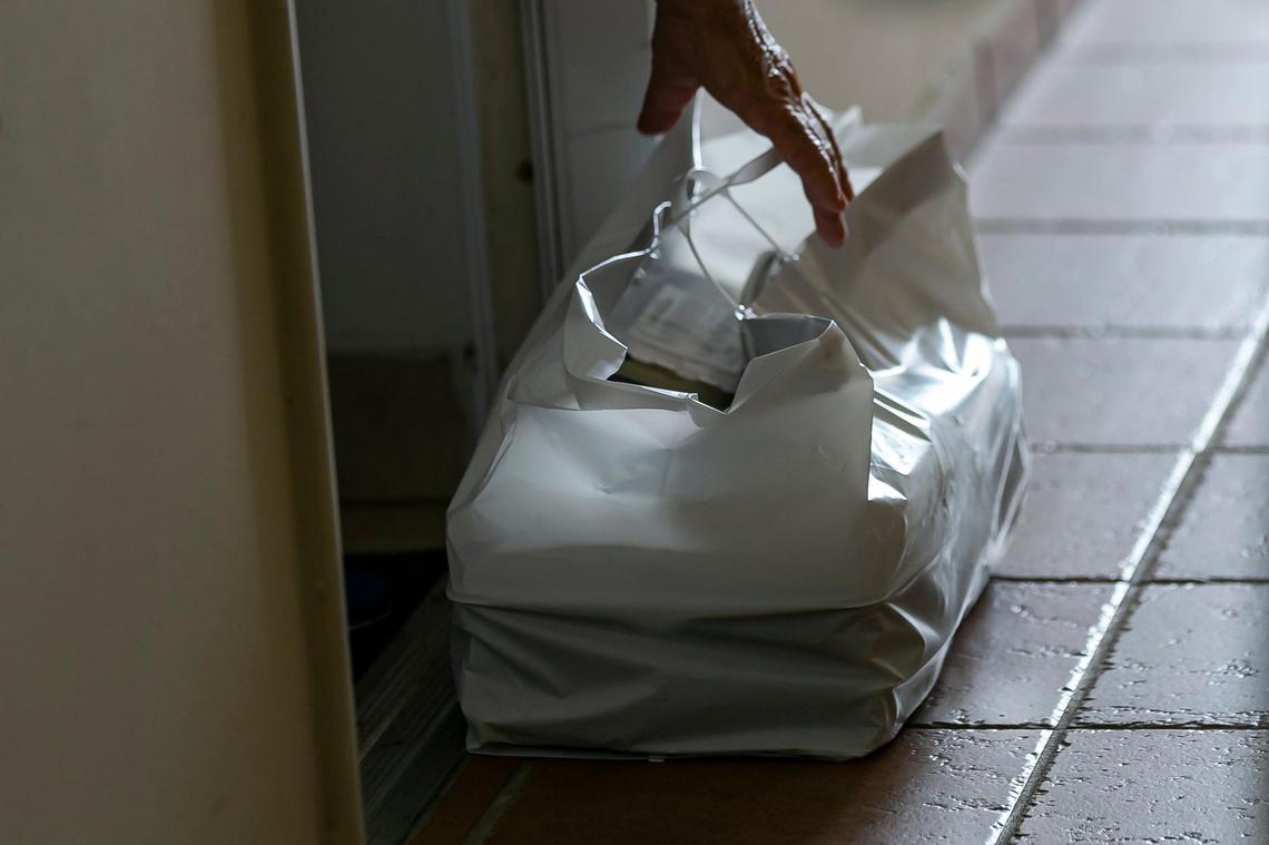 Yuri Kouzenkov, the director of operations for DeliverLean, delivers food to seniors in Brickell, Florida on Wednesday, March 25, 2020. DeliverLean has been hired by Miami-Dade County to help provide elderly residents with free meals during the COVID-19 pandemic.