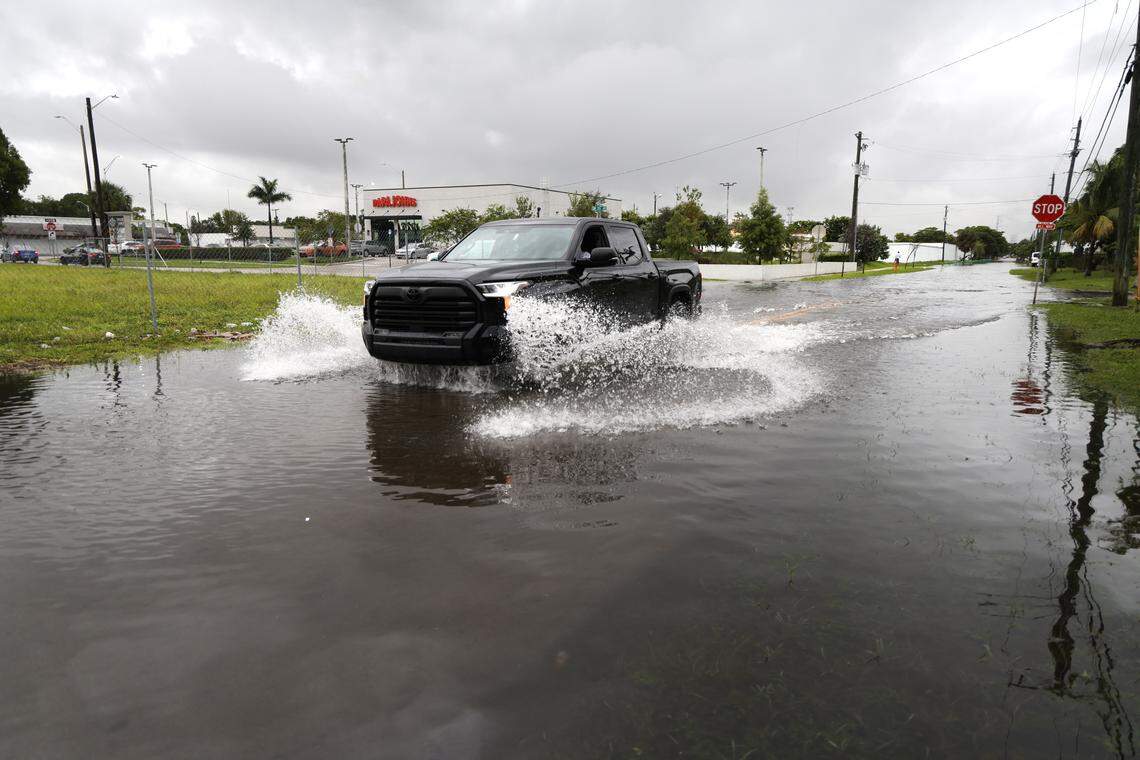 A truck makes its way through a flooded street in the Melrose Park neighborhood in Fort Lauderdale on Friday, Oct. 10, 2025. (Carline Jean/South Florida Sun Sentinel)