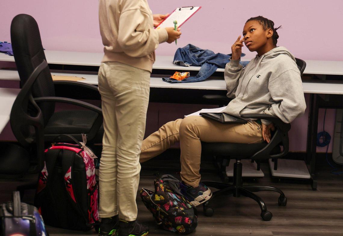 Kayla, 16, a 10th grader, left, and Asante’, 14, an eighth-grader, participate in an after-school program at Girl Power Rocks.