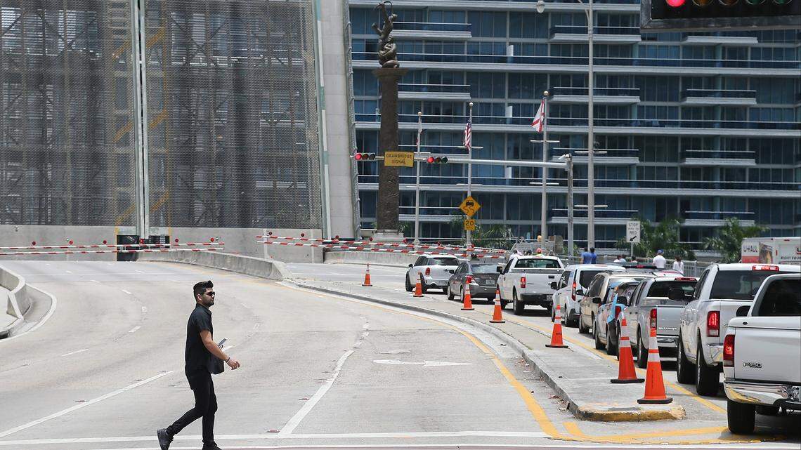 An unidentified pedestrian crosses Brickell Avenue near the drawbridge, which causes traffic backups every time it opens. The long-debated idea of digging a tunnel under the Miami River has gained support as one way to relieve gridlock downtown.