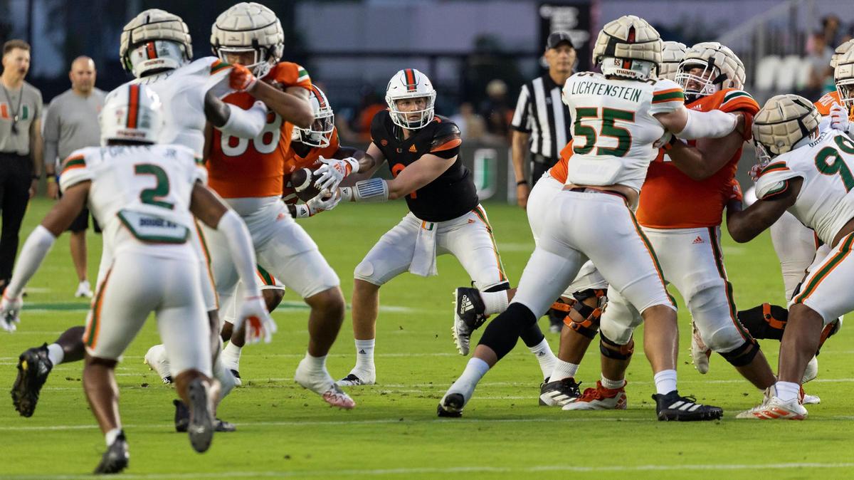 Miami Hurricanes quarterback Tyler Van Dyke (9) passes the ball to Miami Hurricanes running back Henry Parrish Jr. (21) during the first quarter of their spring game at DRV PNK Stadium on Friday, April 14, 2023, in Fort Lauderdale, Fla.
