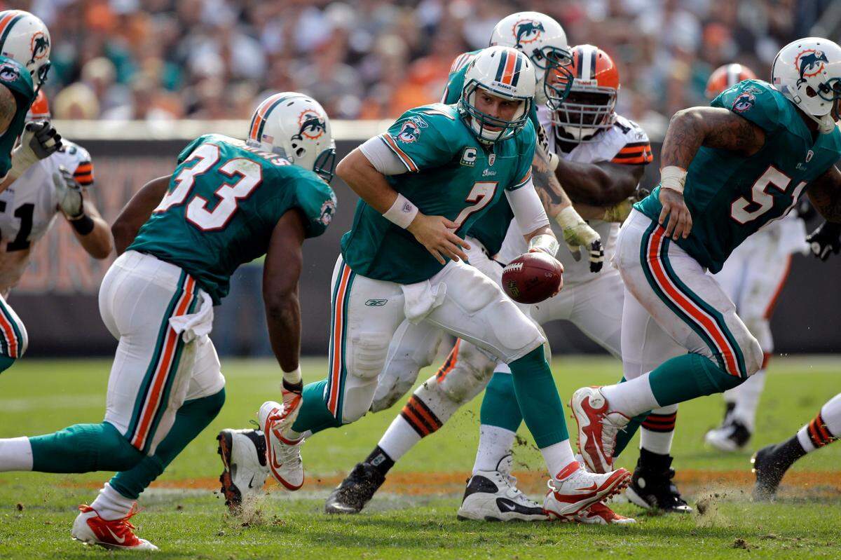 Miami Dolphins quarterback Chad Henne (7) hands off to Miami Dolphins running back Daniel Thomas (33) in an NFL football game against the Cleveland Browns on Sunday, Sept. 25, 2011, in Cleveland.