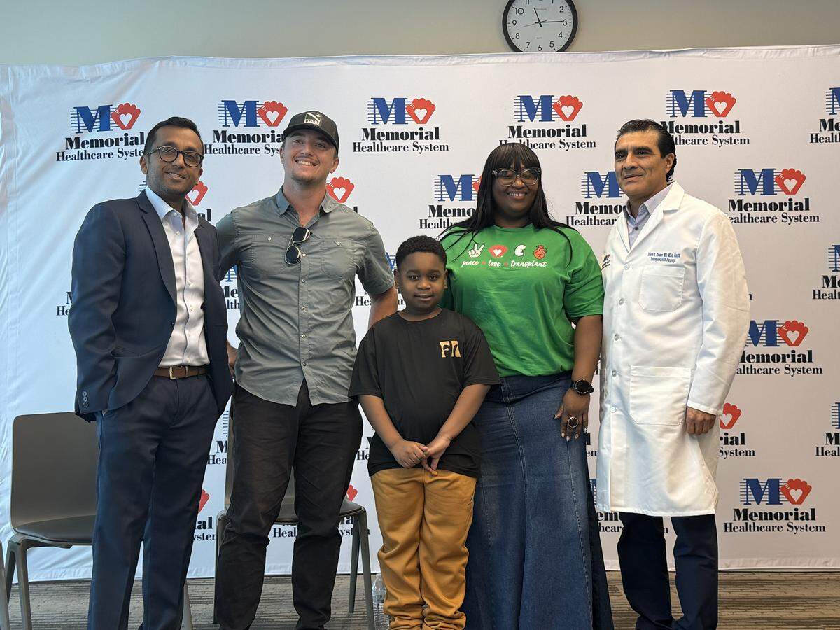 (left to right) Dr. Adarsh Vijay, Nick “Cuda” Kolor, Aaron, his mom Ferline Lamothe and Dr. Edson Franco pose for a photo during a reunion at Memorial Regional Hospital in Hollywood, Florida, on Monday, Dec. 15, 2025.