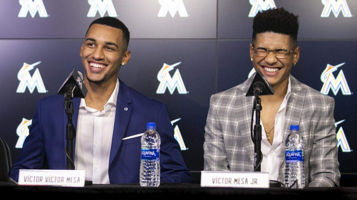 Victor Victor Mesa, left, and his brother, Victor Mesa Jr., react during a press conference announcing their signing to the Miami Marlins at Marlins Park in Little Havana on Monday, Oct. 22, 2018.