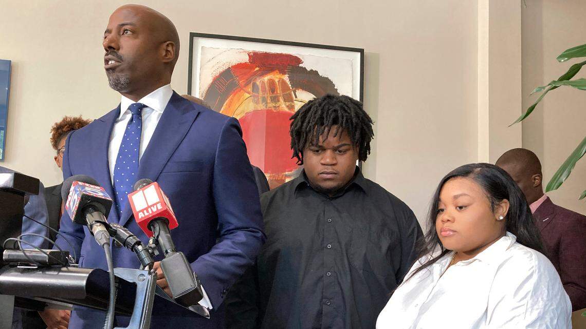 Attorney Cory Lynch, left, joined by Treveon Isaiah Taylor, Sr., Jessica Ross, speaks during a news conference, Wednesday, Aug. 9, in Atlanta.