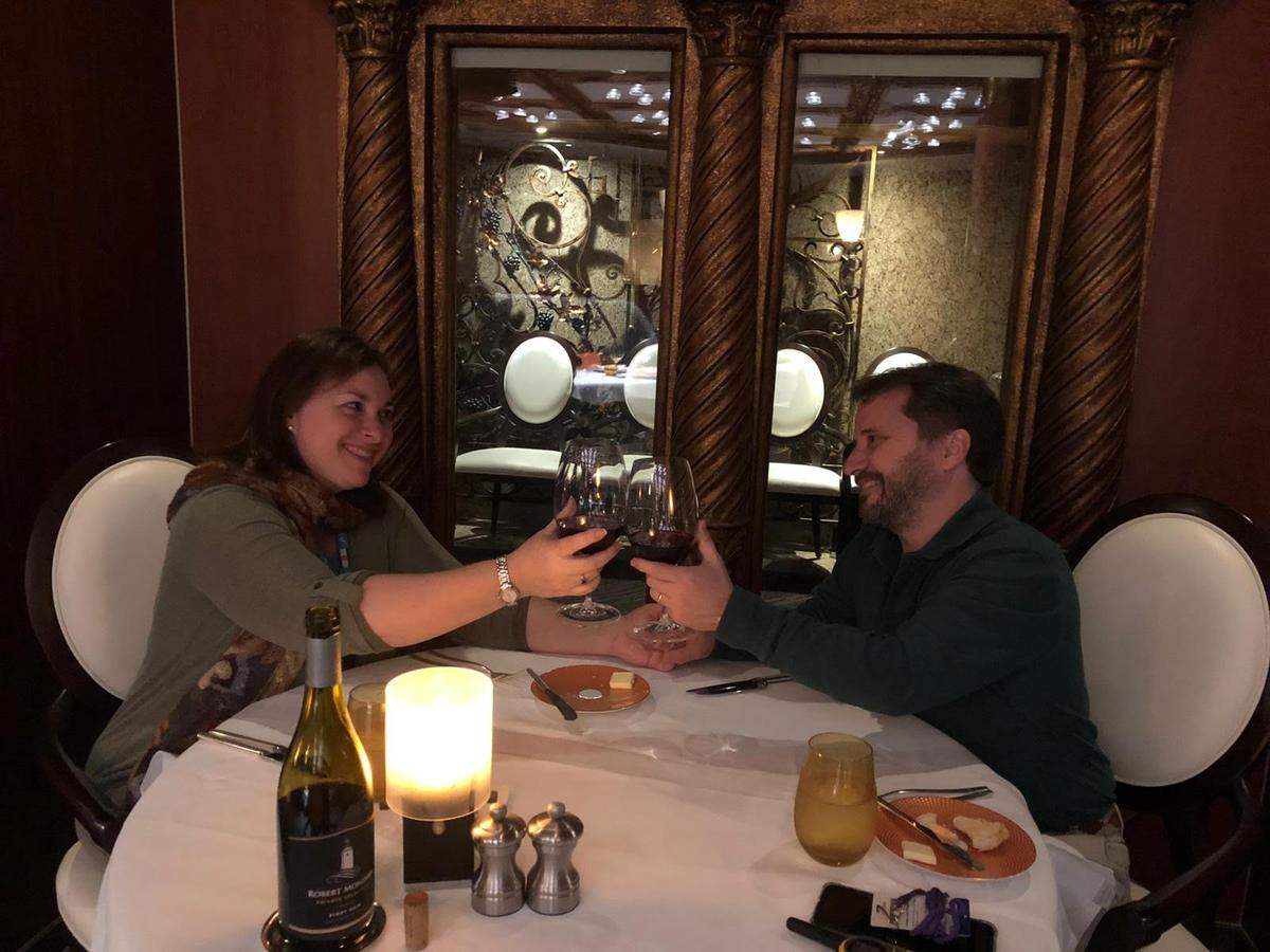 Florida couple Laura Gabaroni Huergo and Juan Huergo toast the start of their voyage aboard the Holland America Zaandam on March 7, at the Pinnacle Grill restaurant. They had no idea at the time that the coronavirus outbreak would leave their ship stranded at sea.