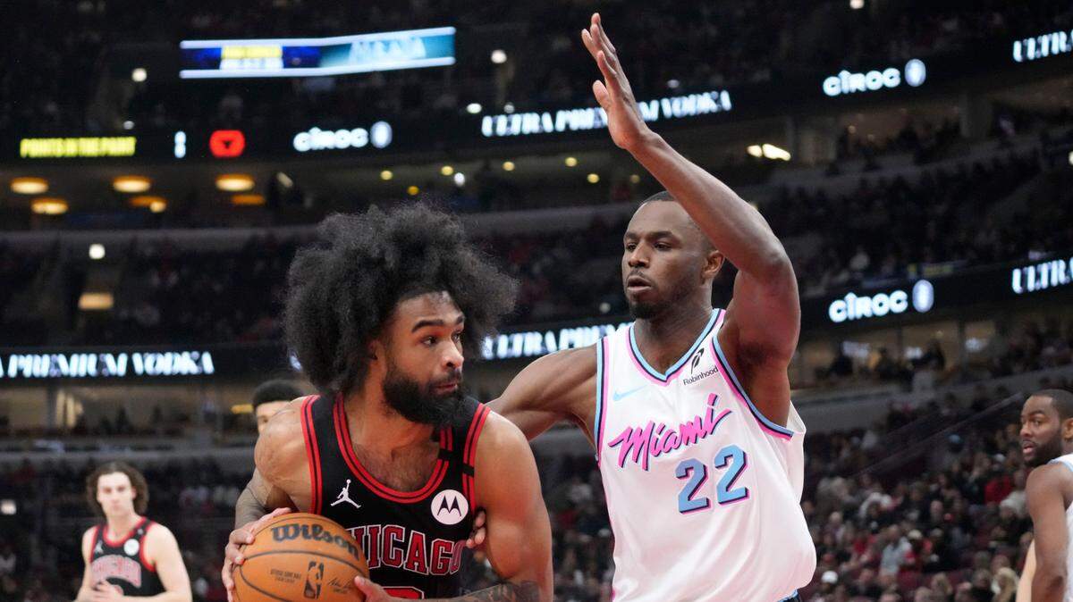 Miami Heat forward Andrew Wiggins (22) defends Chicago Bulls guard Coby White (0) during the first quarter at United Center.