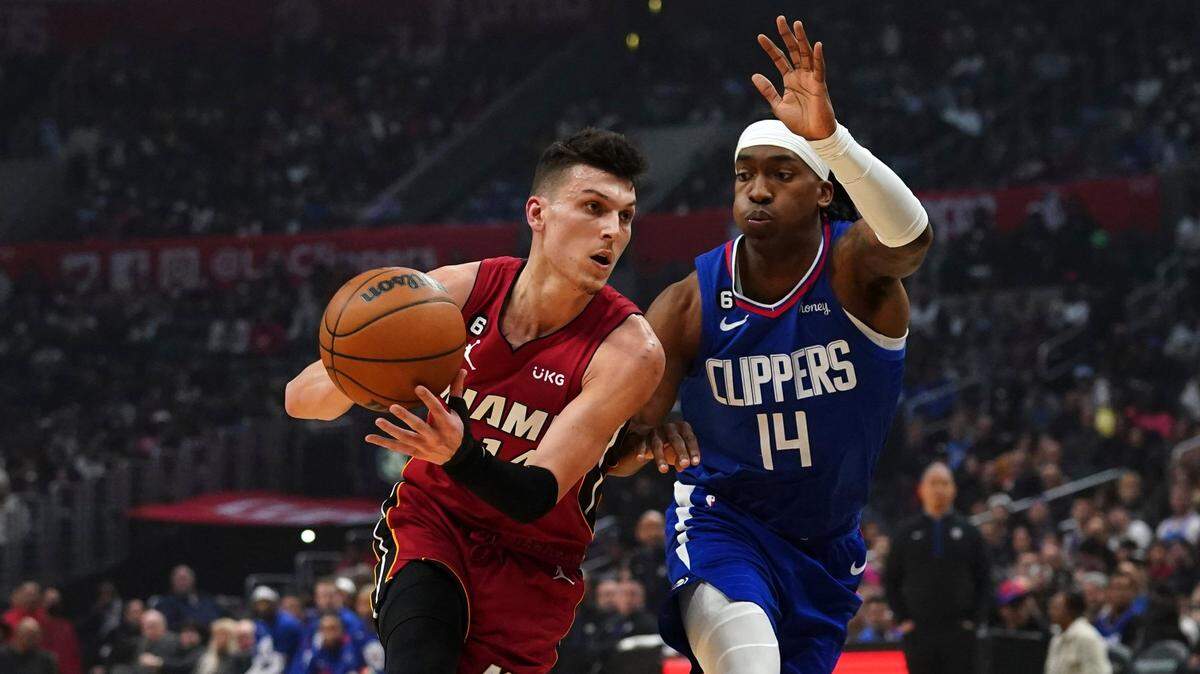 Miami Heat guard Tyler Herro, left, drives to the basket against Los Angeles Clippers guard Terance Mann during the first half of an NBA basketball game, Monday, Jan. 2, 2023, in Los Angeles.