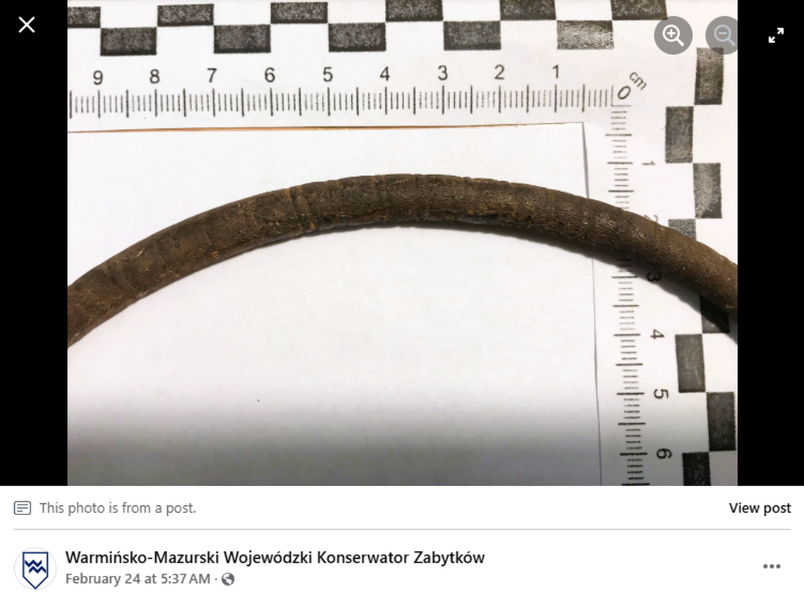 The necklace is decorated with pairings of lines around the entire piece.