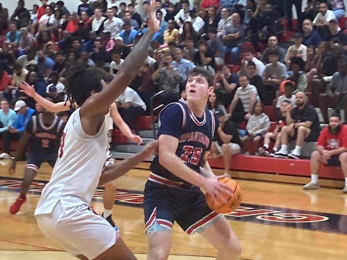 Miami Country Day’s Chaim Galbot goes up for a shot over Chaminade-Madonna’s Matthew Pointer in a Region 4-2A semifinal at Chaminade on Monday night. Galbot led all scorers in the game with 31 points to lead the Spartans.