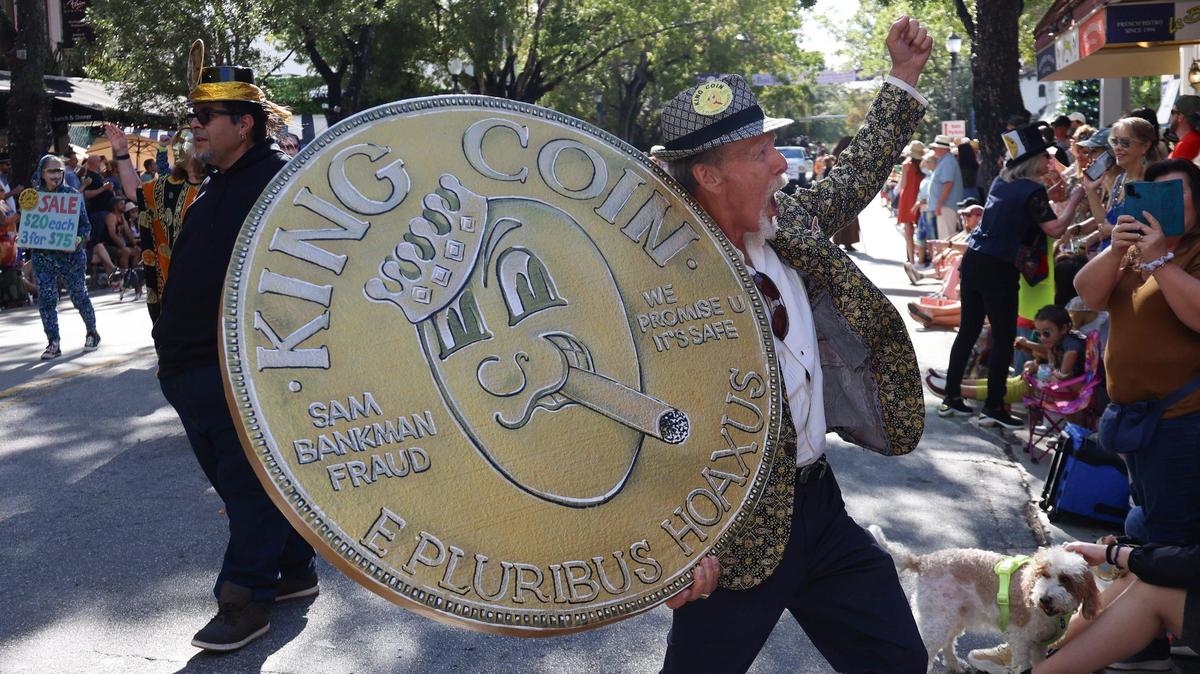 Radio host, humorist, and one of the original organizers of the King Mango Strut, Buzz Fleischan, makes his pitch for “King Coin”’ a riff on the FTX debacle, as he tries to con parade attendees into purchasing the worthless digital currency. The 39th Annual King Mango Strut, Coconut Grove’s famous and most iconic satirical parade, took place on Sunday, Jan. 8, 2023, and kicked off the month-long celebration of the 150th anniversary of the founding of Coconut Grove.