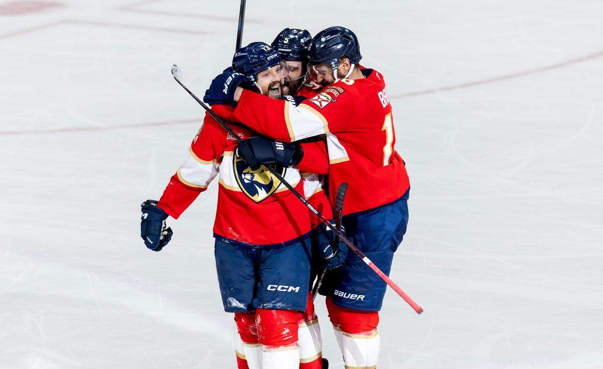 Florida Panthers center Sam Reinhart (13) celebrates with Aaron Ekblad (5) and Aleksander Barkov (16) after scoring his fourth goal of the game against the Edmonton Oilers during the third period of Game 6 in the NHL Stanley Cup Final at Amerant Bank Arena on Tuesday, June 17, 2025, in Sunrise, Fla.