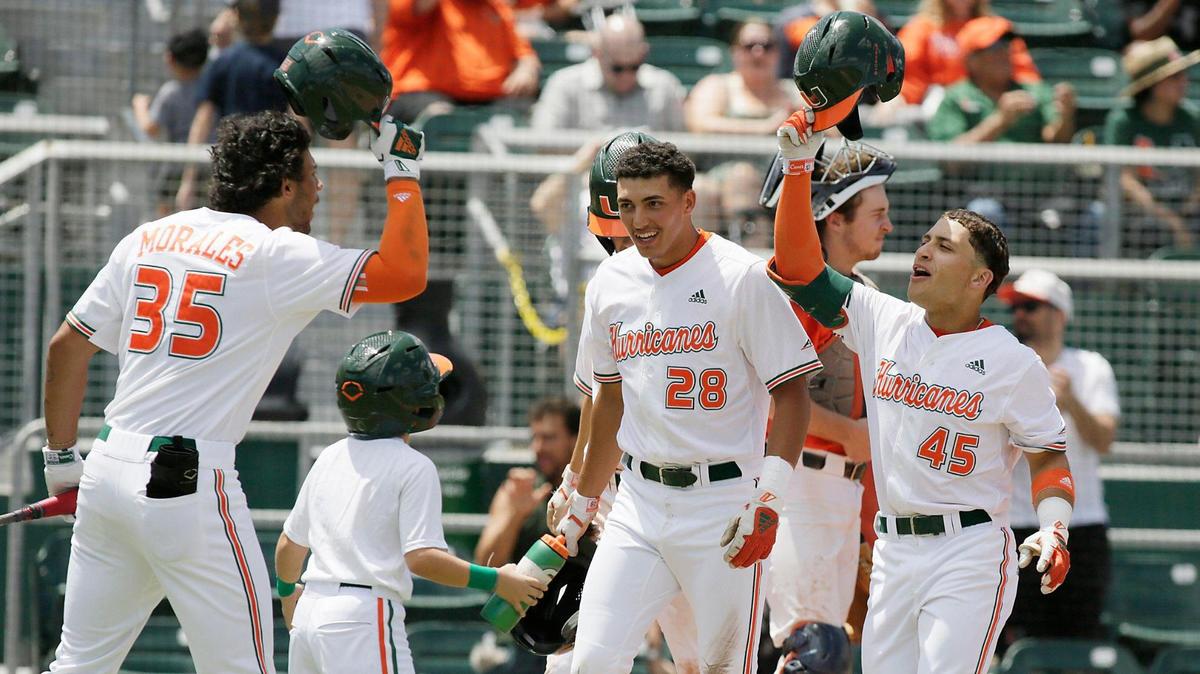 UM Hurricanes Yohandy Morales (35), Ariel Garcia (28) and Edgardo Villegas (45) celebrate Villegas’s 3-run home run in the third inning of the baseball game against UVA Cavaliers on Sunday, April 10, 2022 at Alex Rodriguez Park at Mark Light Field in Coral Gables. Andrew Uloza / for THE MIAMI HERALD