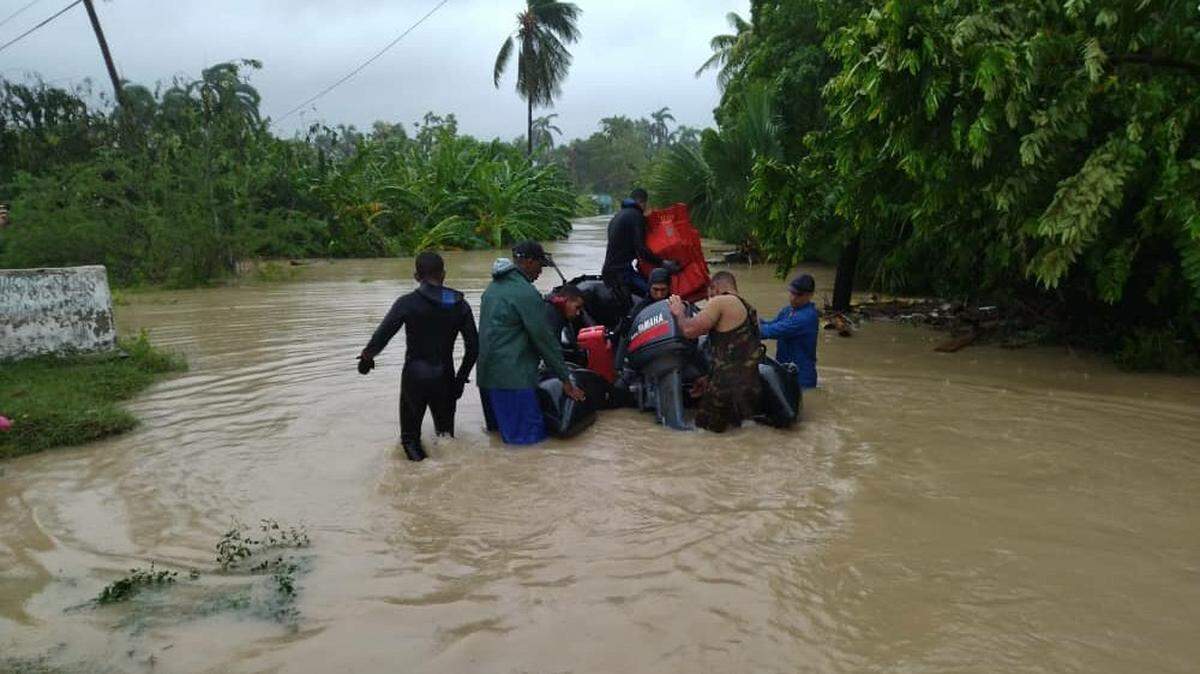 Rescue operations Monday to help people trapped by flooding caused by Hurricane Oscar on eastern Cuba.