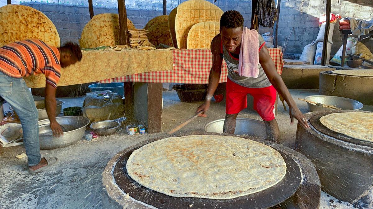 Josnel Pierre prepares kasav or cassava flatbread in Haiti, on Friday, January 20, 2023. The staple food, which has no fat or sourdough, is still prepared the way it was made centuries ago.