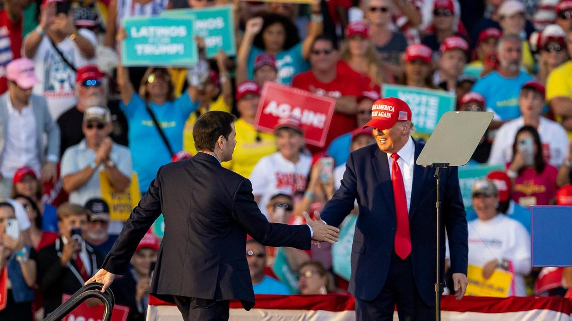 Former President Donald Trump shakes hands with Sen. Marco Rubio, left, during a political rally at the Miami-Dade County Fair and Exposition Fairgrounds on Sunday, Nov. 6, 2022, in Miami, Florida.
