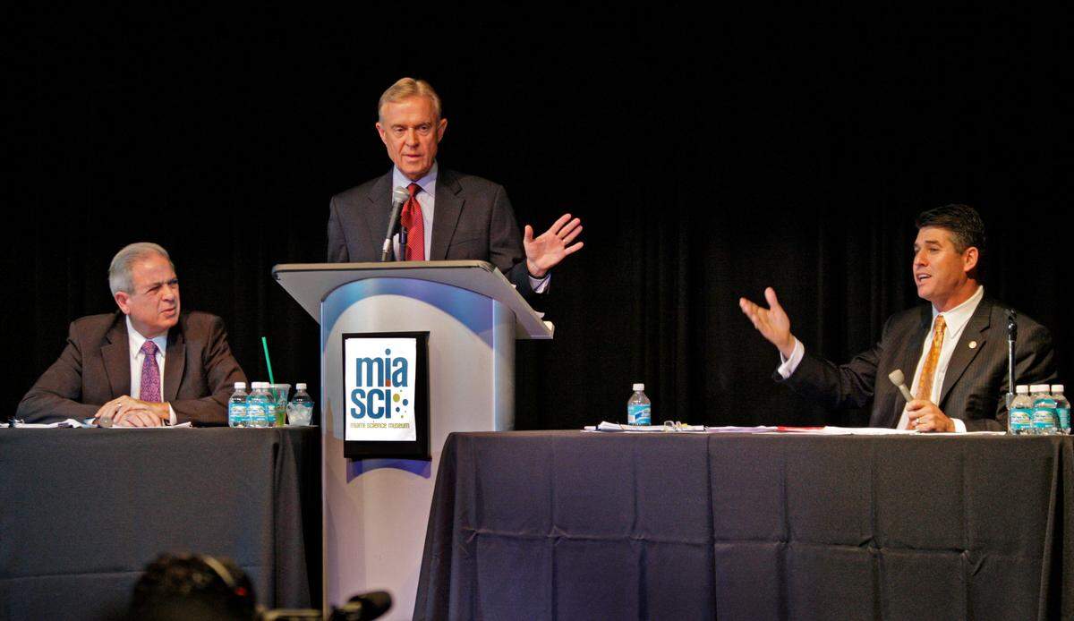 In this file photo from Sept. 16, 2009, Michael Putney, senior political reporter at WPLG-Channel 10, moderated the first major debate in the race for Miami mayor between Tomás Regalado and Joe Sanchez at the former Miami Science Museum.