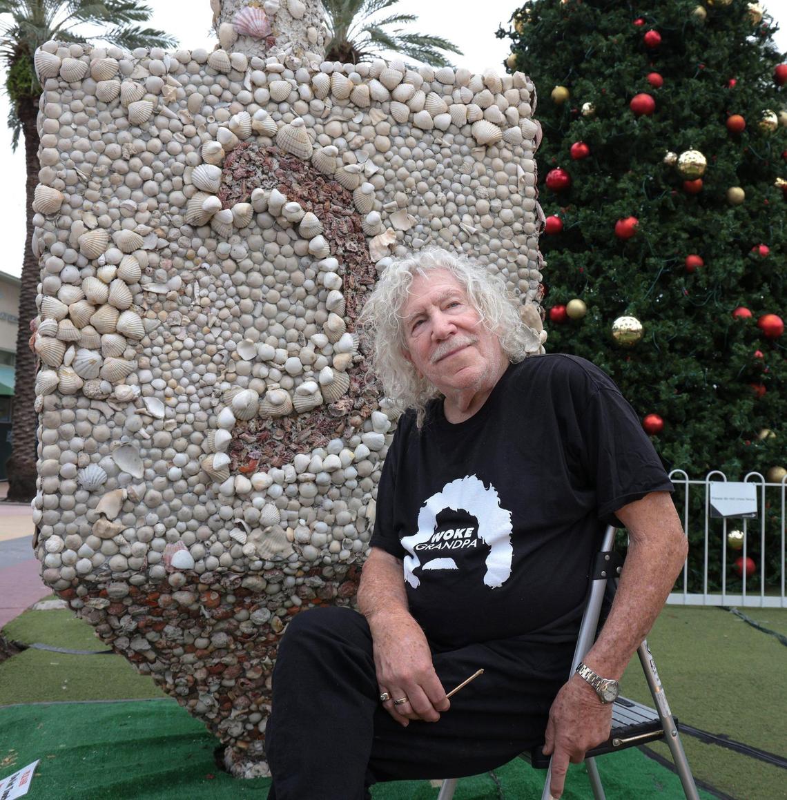 Roger Abramson is photographed near the dreidel he created out of seashells 20 years ago. It’s still used to celebrate Hanukkah on Lincoln Road. On Nov. 18, Abramson, 87, climbed on a ladder to fix shells that have fallen off.