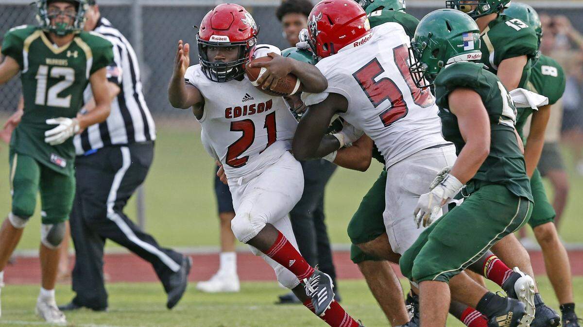 Miami Edison Red Raiders Steve Mitts (21) breaks tackles in the third quarter as Westminster Christian hosts Edison High at football at Westminster Christian in Palmetto Bay on Friday, November 8, 2019.