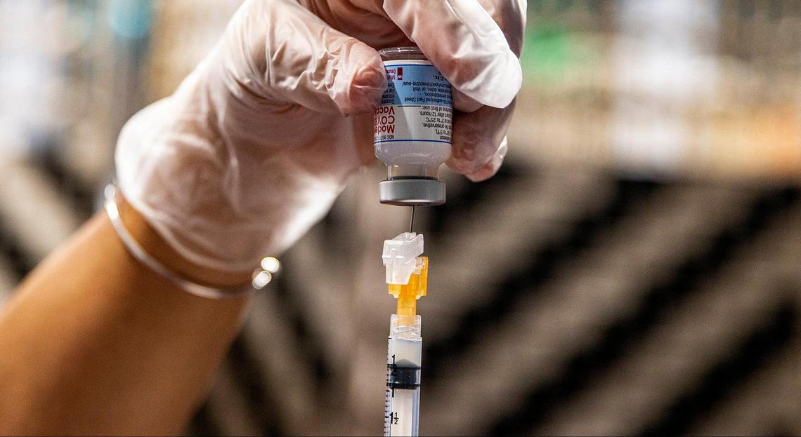 A nurse for Miami Jewish Health, a long-term care facility, prepares a dose of the Moderna vaccine for COVID-19 to administer to an employee on August 19, 2021.